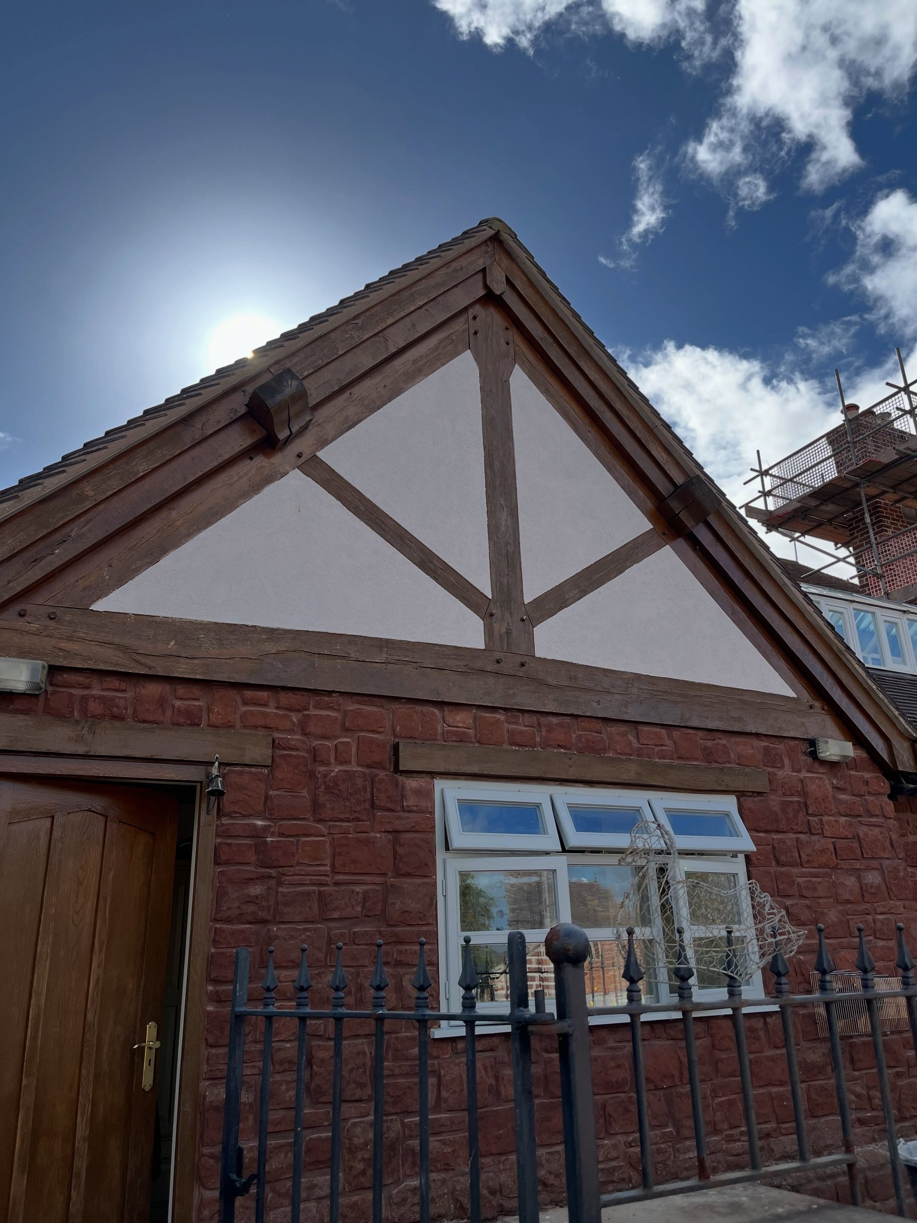 A Tudor-style gable freshly rendered in white K Rend between dark timbers
