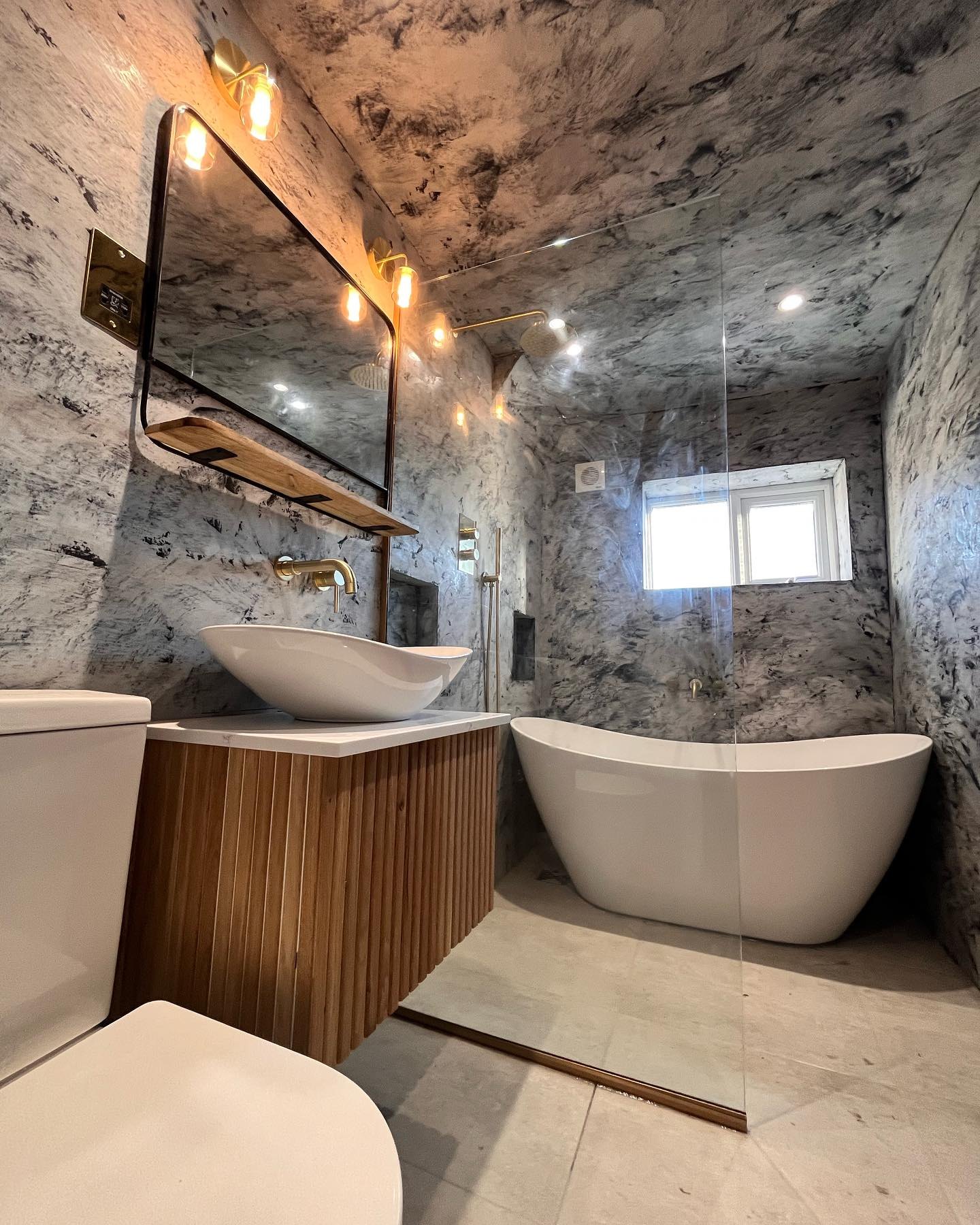 Two-tone tadelakt bathroom with a vessel basin, freestanding bath and walk-in shower