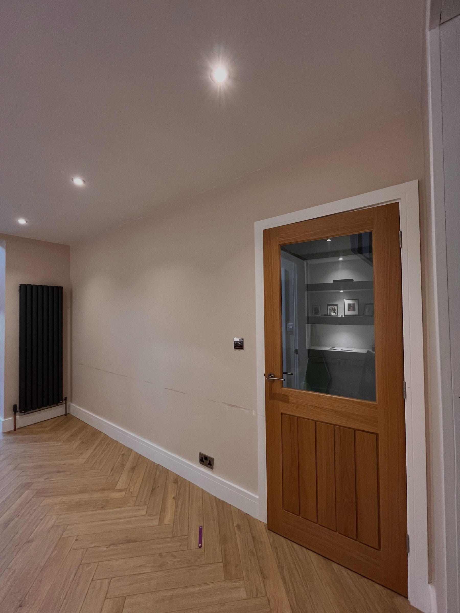 The same hallway wall before, plain and painted